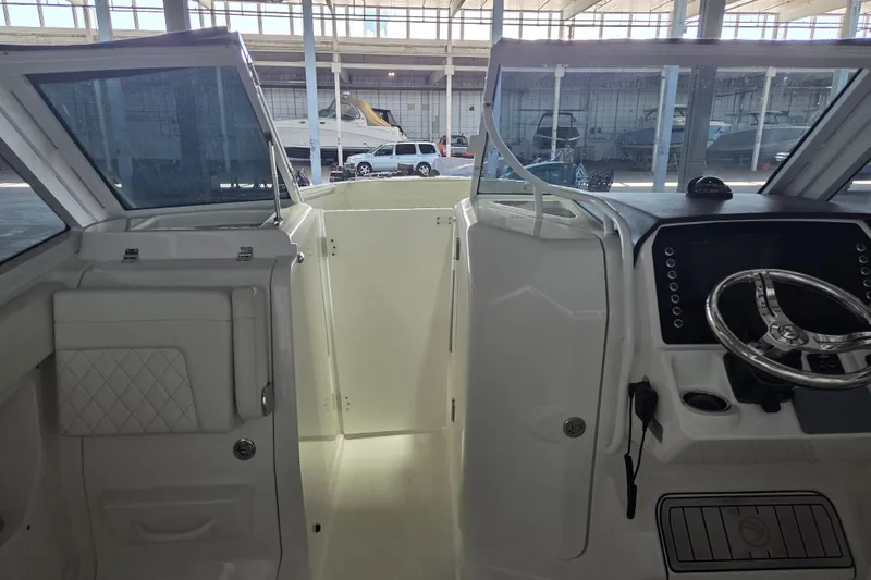 Slide: The Image of Interior view of 2019 Edgewater 262CX Crossover boat cockpit with steering wheel. - 21