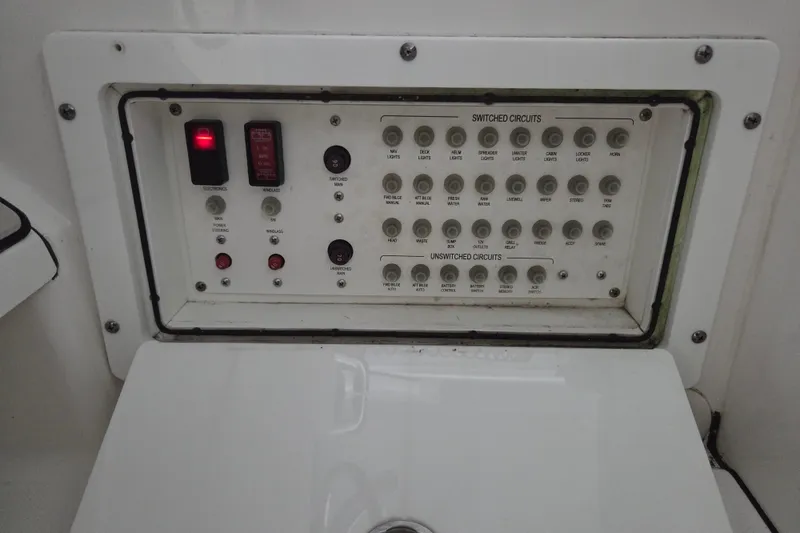 Slide: The Image of Electrical panel of a 2019 Edgewater 262CX Crossover boat with switched and unswitched circuits. - 24