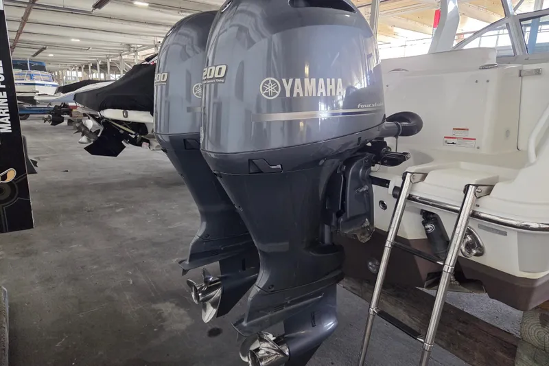 Slide: The Image of Twin Yamaha outboard engines on a 2019 Edgewater 262CX Crossover boat in storage. - 5