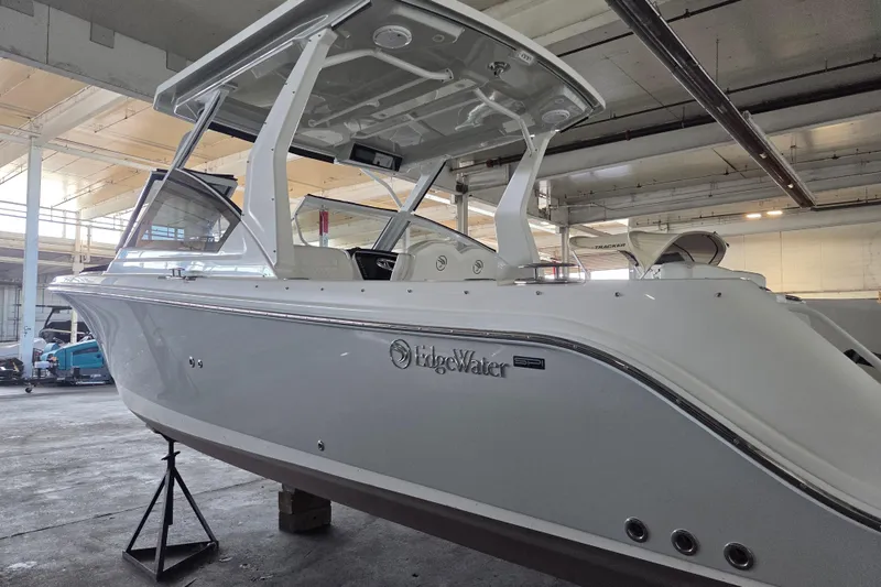 Slide: The Image of 2019 Edgewater 262CX Crossover boat in indoor storage facility. - 8