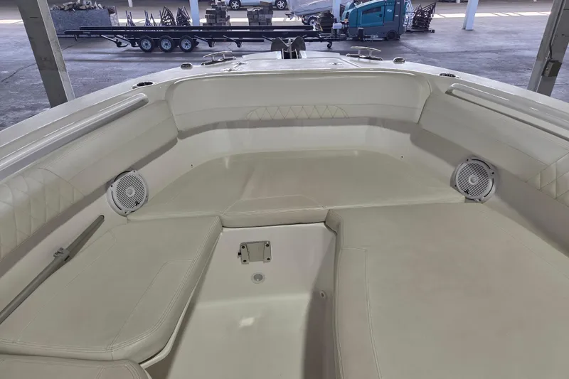 Slide: The Image of Interior view of 2019 Edgewater 262CX Crossover boat with cushioned seating and speakers. - 9