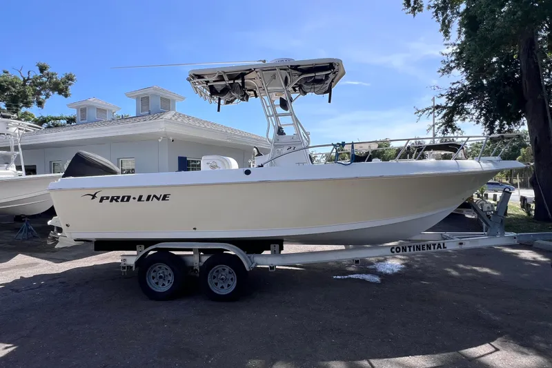 Slide: The Image of 2006 Pro-Line 23 Sport boat on trailer, parked outdoors under clear sky. - 1