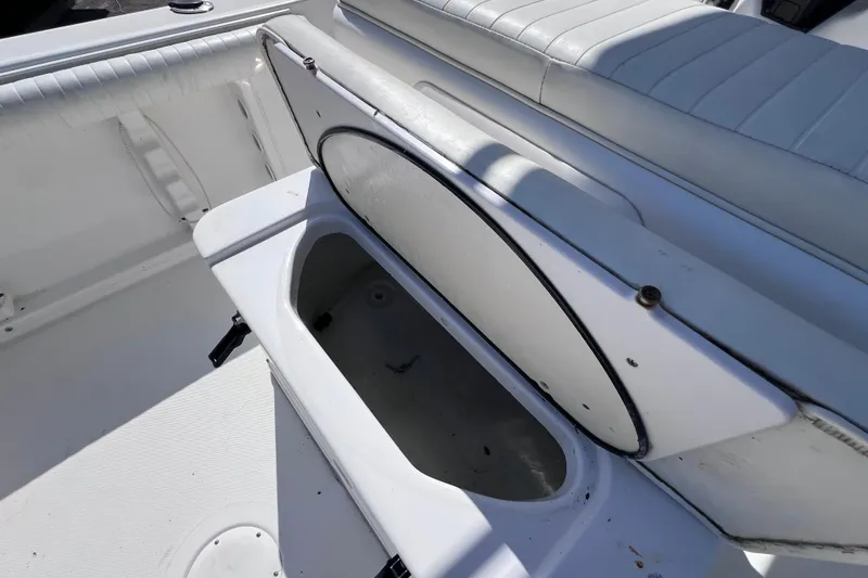 Slide: The Image of 2006 Pro-Line 23 Sport boat interior with open storage compartment and white seating. - 10
