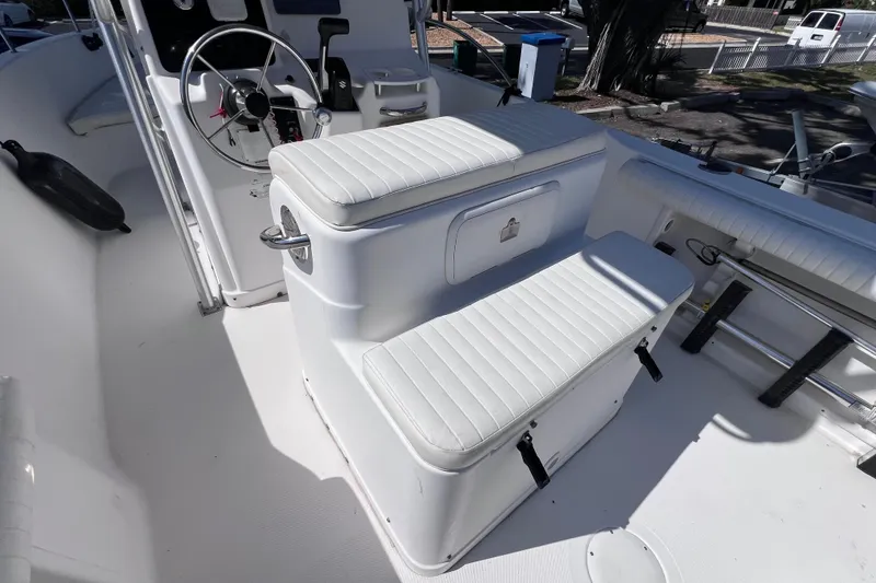 Slide: The Image of 2006 Pro-Line 23 Sport boat interior with white seating and steering wheel. - 11