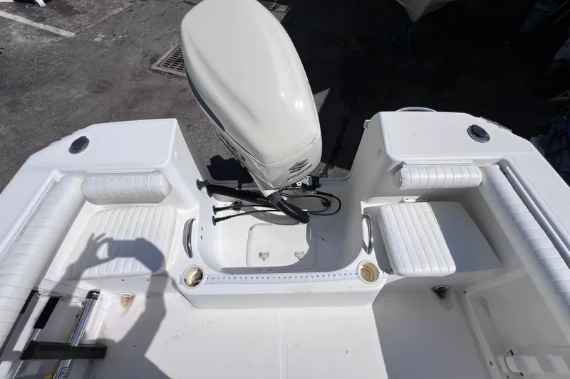 Slide: The Image of 2006 Pro-Line 23 Sport boat interior with seating and outboard motor. - 13