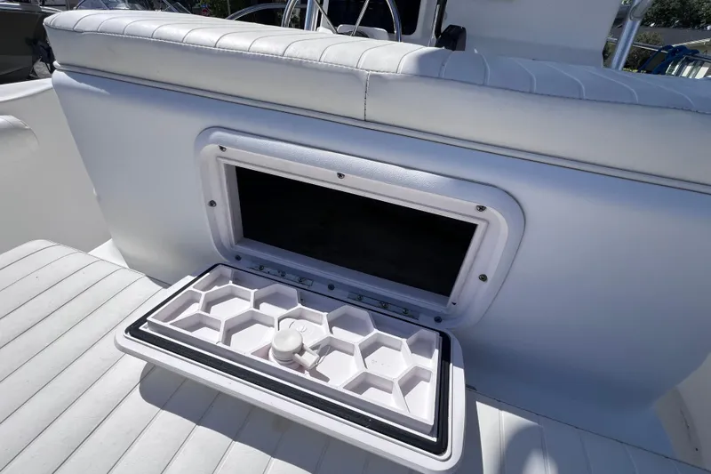 Slide: The Image of 2006 Pro-Line 23 Sport boat seat with open storage compartment. - 14
