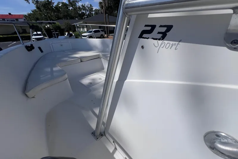 Slide: The Image of 2006 Pro-Line 23 Sport boat interior with seating and railing, parked outdoors. - 17