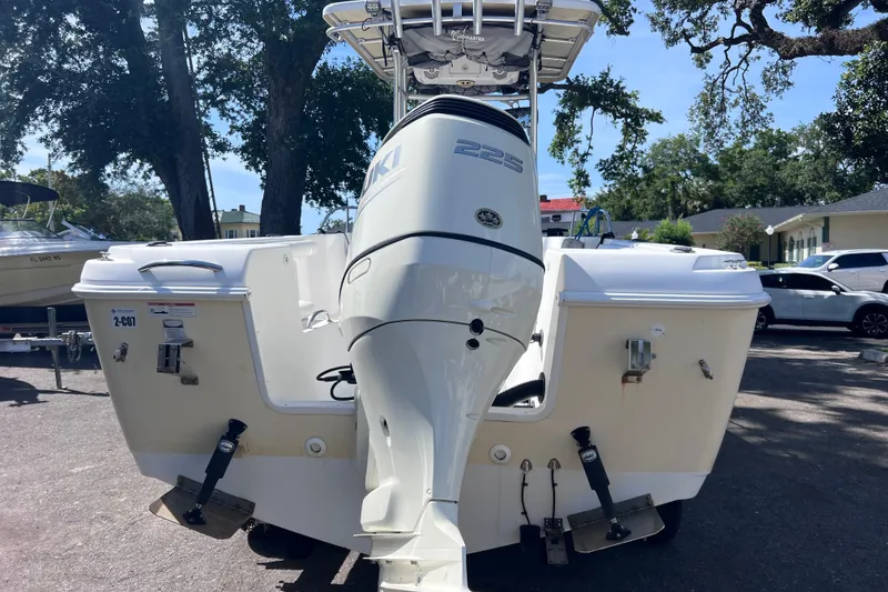 Slide: The Image of 2006 Pro-Line 23 Sport boat with Suzuki 225 outboard motor, parked outdoors. - 4