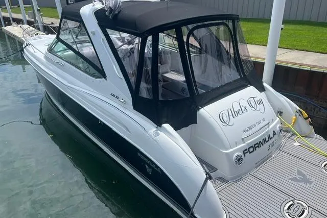 The Image of 2004 Formula 370 Super Sport boat docked, featuring sleek design and black canopy. - 0