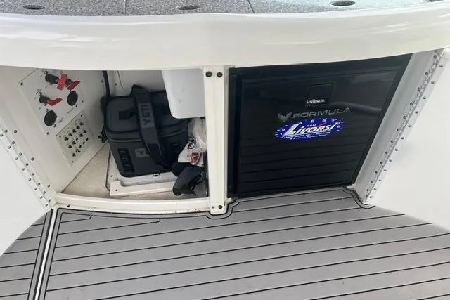 Slide: The Image of Storage compartment of a 2004 Formula 370 Super Sport boat with equipment and controls. - 14