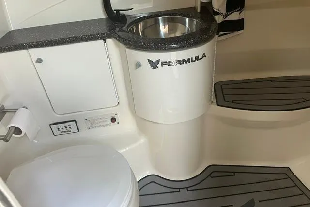 Slide: The Image of 2004 Formula 370 Super Sport boat bathroom with sink and toilet. - 15