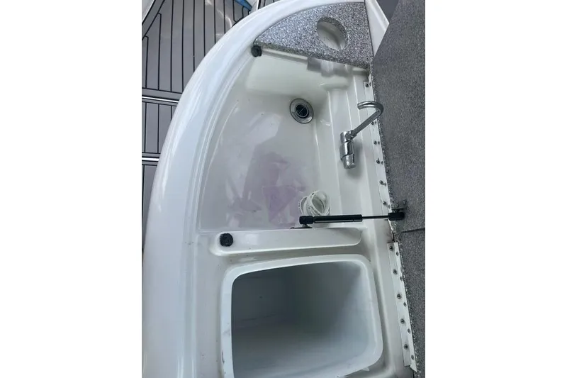 Slide: The Image of 2004 Formula 370 Super Sport boat sink and storage compartment. - 16