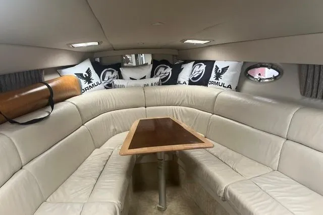 Slide: The Image of Interior of 2004 Formula 370 Super Sport boat with plush seating and decorative pillows. - 18
