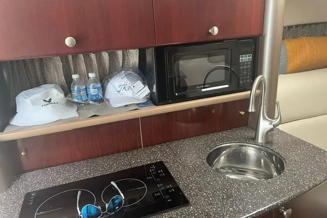 Slide: The Image of 2004 Formula 370 Super Sport yacht interior with kitchenette, microwave, and sink. - 19