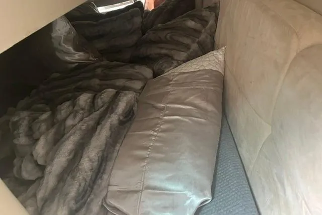 Slide: The Image of Cozy interior of a 2004 Formula 370 Super Sport boat with plush bedding. - 22