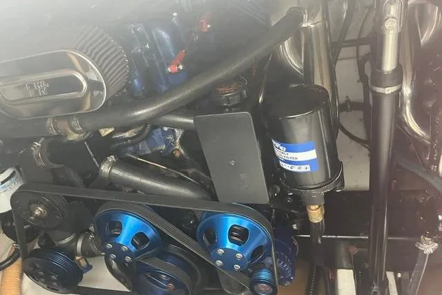 Slide: The Image of Engine compartment of a 2004 Formula 370 Super Sport with visible blue pulleys and components. - 25