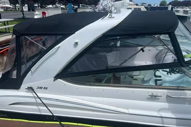 Slide: The Image of 2004 Formula 370 Super Sport boat with black canopy docked at marina. - 3