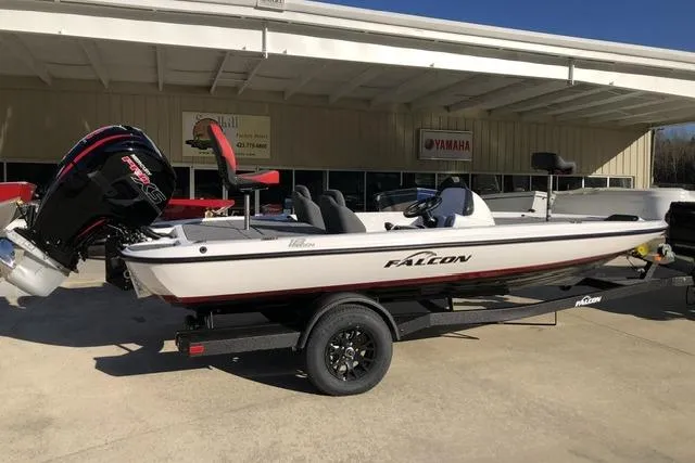 The Image of 2025 Falcon Boats 18 Freedom on trailer, displayed outdoors with Yamaha signage in background. - 1
