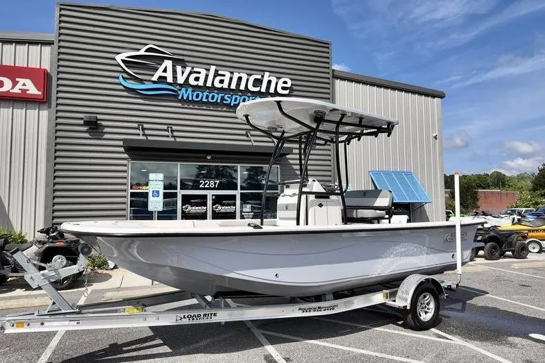 The Image of 2026 Carolina Skiff 21 LS boat on trailer at Avalanche Motorsports dealership. - 1