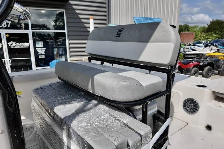 Slide: The Image of 2026 Carolina Skiff 21 LS boat seat with gray upholstery, outdoor dealership setting. - 10