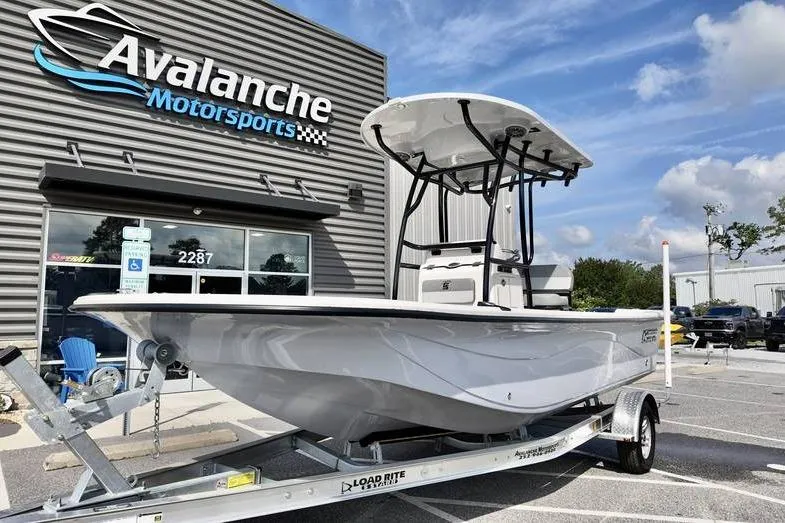 Slide: The Image of 2026 Carolina Skiff 21 LS boat on trailer at Avalanche Motorsports dealership. - 2