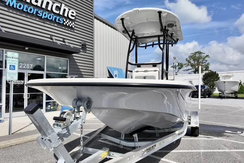 Slide: The Image of 2026 Carolina Skiff 21 LS boat on trailer outside dealership under blue sky. - 3
