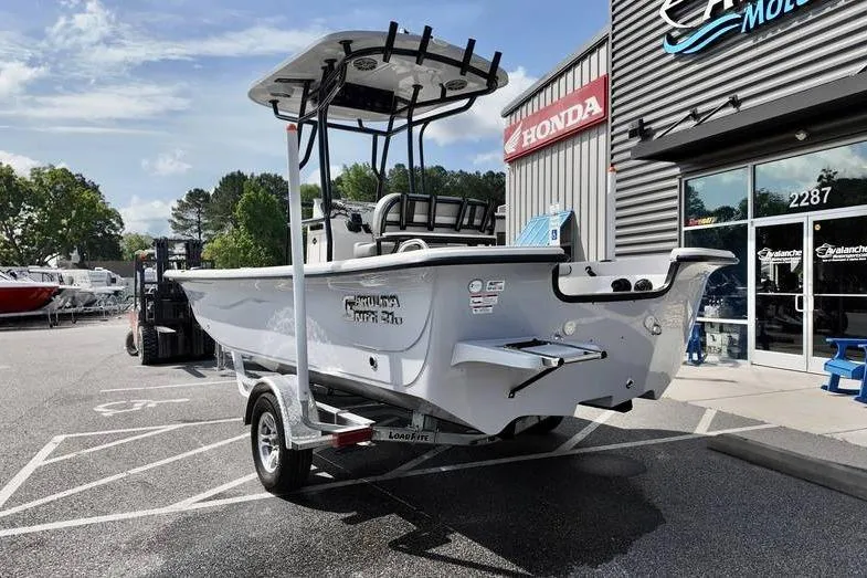 Slide: The Image of 2026 Carolina Skiff 21 LS boat on trailer outside dealership, sunny day. - 4