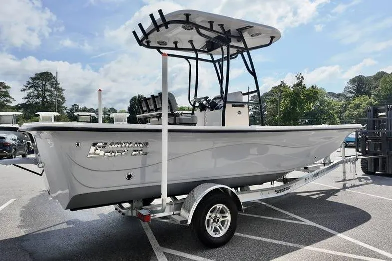 Slide: The Image of 2026 Carolina Skiff 21 LS boat on trailer in parking lot, sunny day. - 5