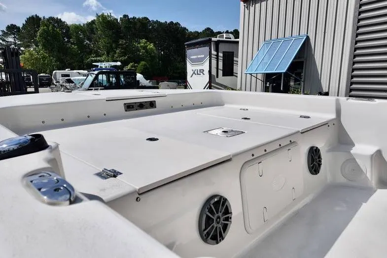 Slide: The Image of 2026 Carolina Skiff 21 LS boat interior with storage compartments and speakers. - 8