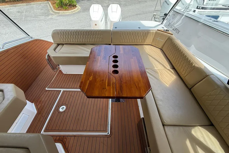 Slide: The Image of Luxurious 2024 Hanover 387 boat interior with wooden table and cushioned seating. - 10