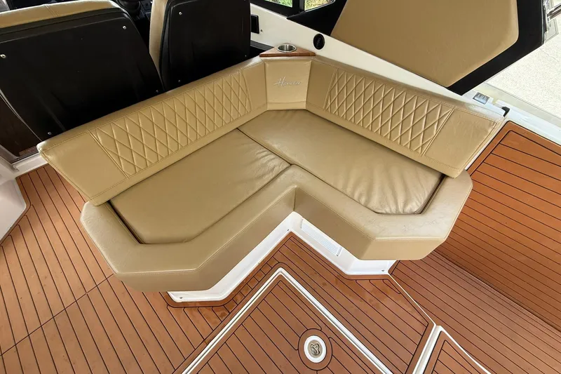 Slide: The Image of Luxurious seating on 2024 Hanover 387 boat with tan upholstery and teak flooring. - 11