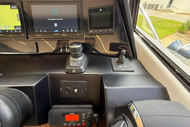 Slide: The Image of Control panel of a 2024 Hanover 387 boat with navigation screens and joystick. - 16