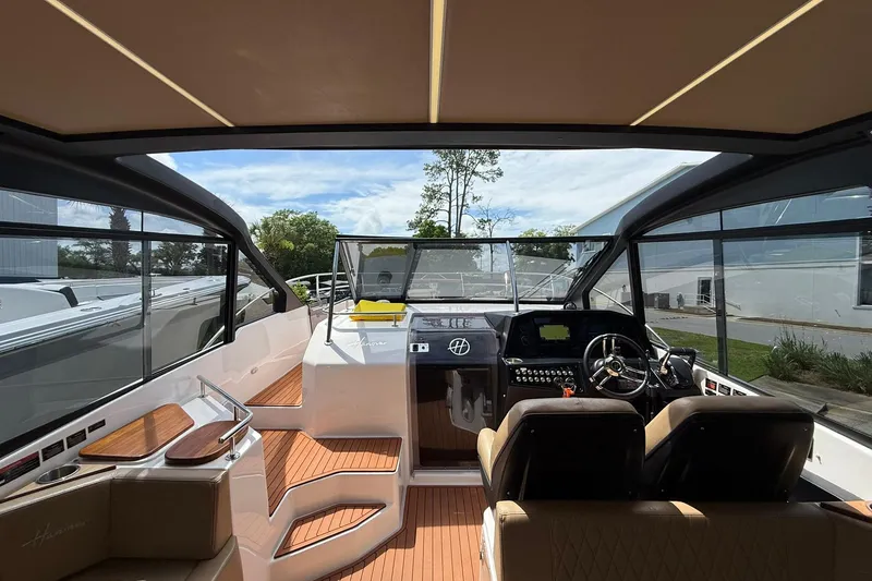 Slide: The Image of Interior view of 2024 Hanover 387 boat, featuring modern cockpit and seating. - 20
