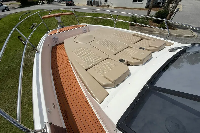 Slide: The Image of 2024 Hanover 387 boat with tan sunbathing cushions and sleek deck design. - 21