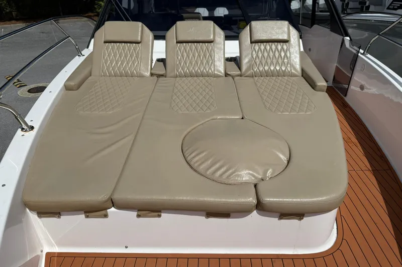 Slide: The Image of Luxurious seating on 2024 Hanover 387 boat with beige cushions and diamond stitching. - 23