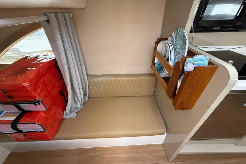 Slide: The Image of Compact seating area in 2024 Hanover 387 RV with storage and kitchenware. - 29