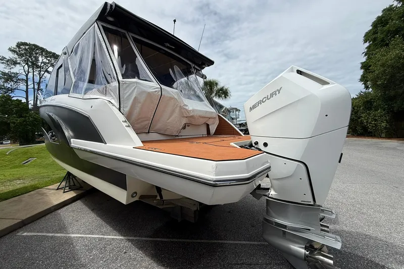 Slide: The Image of 2024 Hanover 387 boat with Mercury outboard engine, parked on a paved surface. - 3
