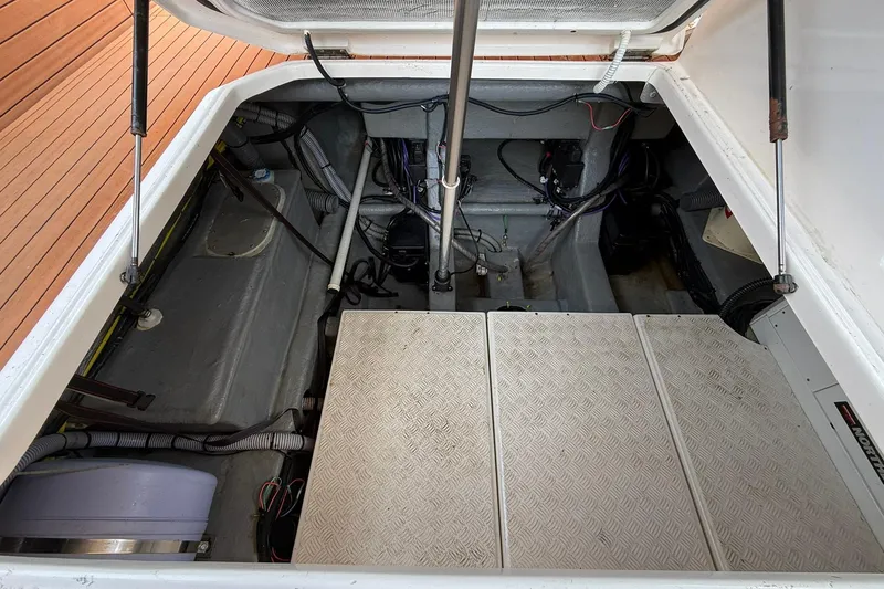 Slide: The Image of Open engine compartment of 2024 Hanover 387 boat, showcasing mechanical components and wiring. - 36