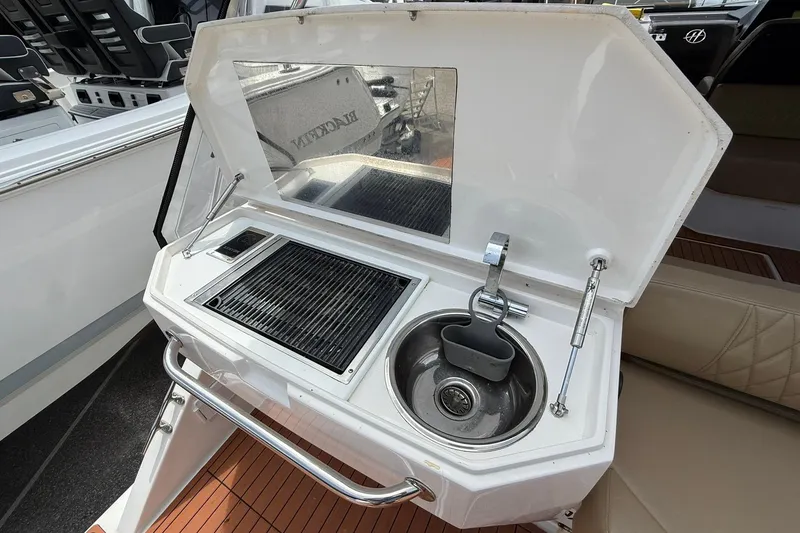 Slide: The Image of 2024 Hanover 387 boat kitchenette with grill and sink, featuring modern design and functionality. - 6