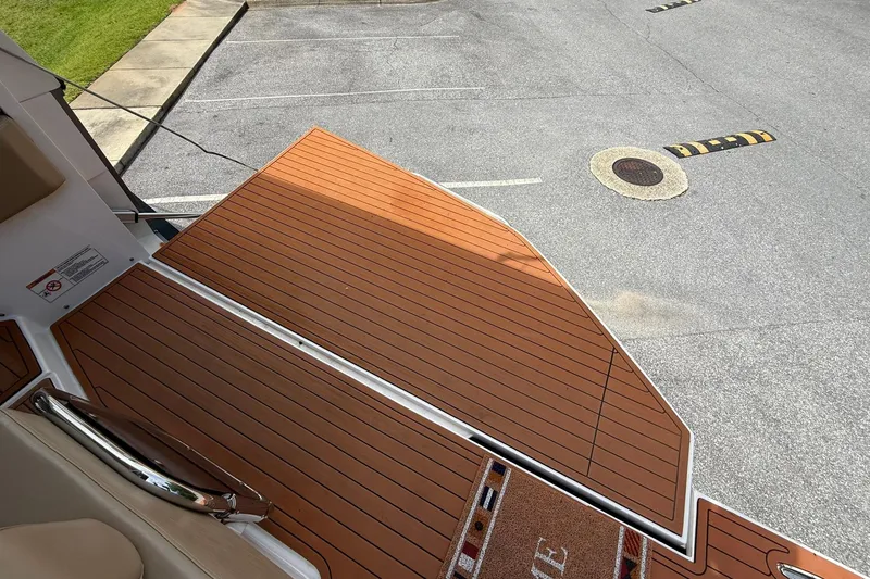 Slide: The Image of 2024 Hanover 387 boat deck with wood finish, parked on asphalt. - 8