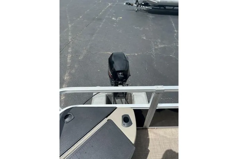 Slide: The Image of 2023 SUNTRACKER Fishing Barge 20 with outboard motor on a trailer. - 10