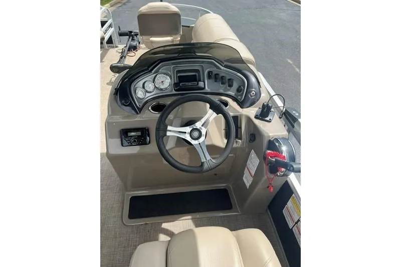 Slide: The Image of 2023 SUNTRACKER Fishing Barge 20 dashboard with steering wheel and controls. - 7