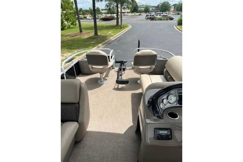 Slide: The Image of 2023 SUNTRACKER Fishing Barge 20 interior with seating and control panel. - 9
