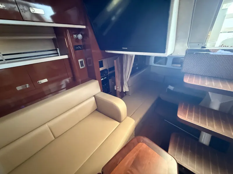 Slide: The Image of Interior of a 2012 Sea Ray Sundancer 350 yacht with sofa and TV. - 24