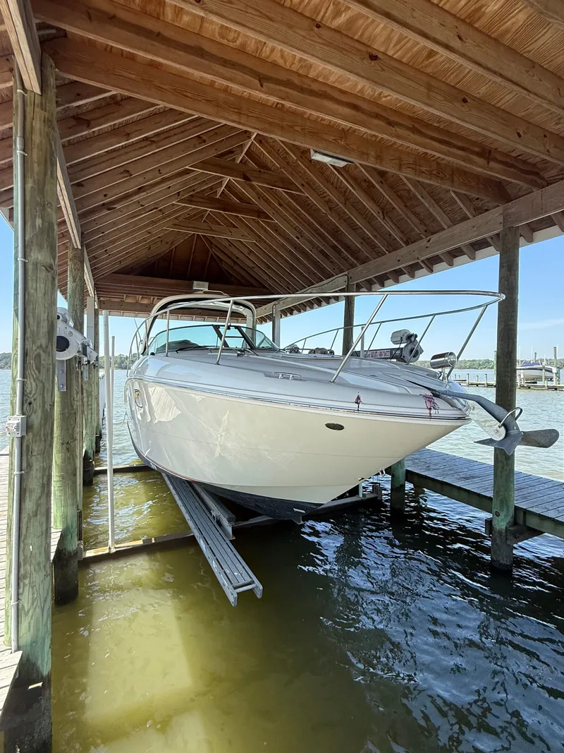 Slide: The Image of 2012 Sea Ray Sundancer 350 under a wooden boathouse. - 3