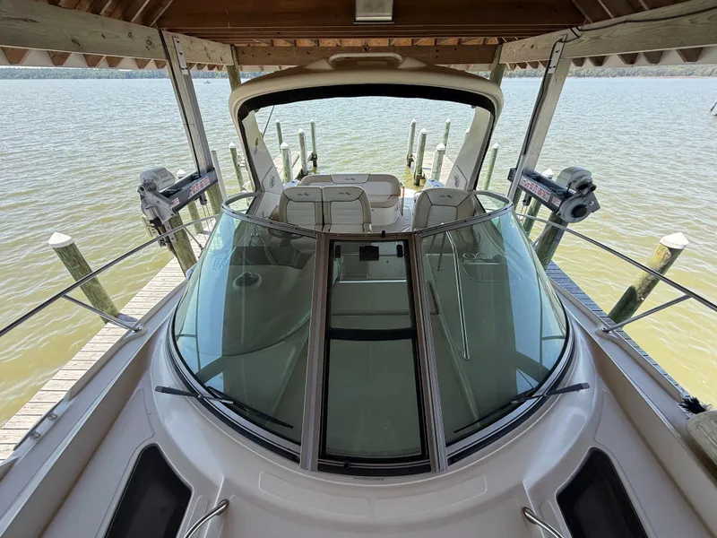 Slide: The Image of 2012 Sea Ray Sundancer 350 in a boathouse on a lake. - 35