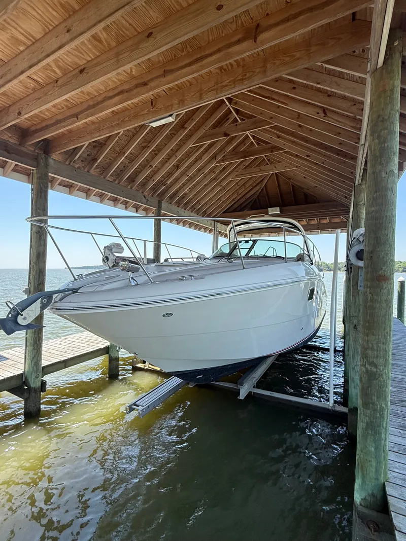 Slide: The Image of 2012 Sea Ray Sundancer 350 under a wooden boathouse. - 4
