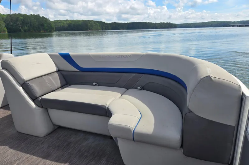 Slide: The Image of 2023 Bennington 22 SSR boat interior with plush seating on a serene lake. - 10