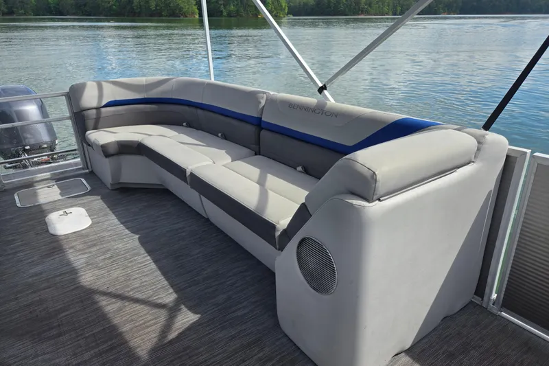 Slide: The Image of 2023 Bennington 22 SSR pontoon boat with spacious seating on a serene lake. - 12
