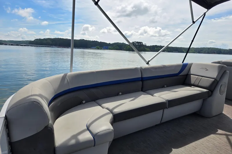 Slide: The Image of 2023 Bennington 22 SSR pontoon boat interior with lake view and comfortable seating. - 14